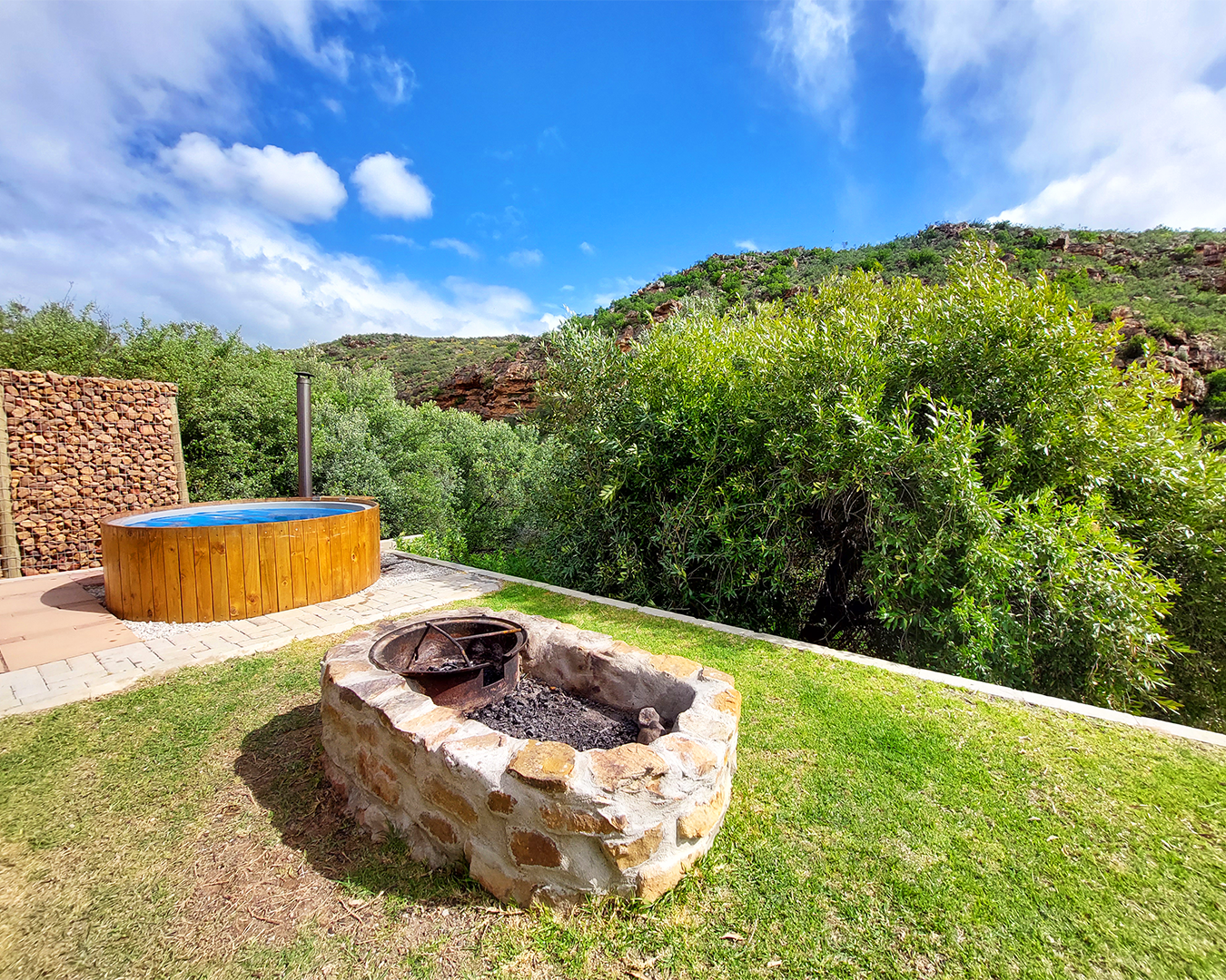 Farm cottage exterior showing hot tub and fire pit area