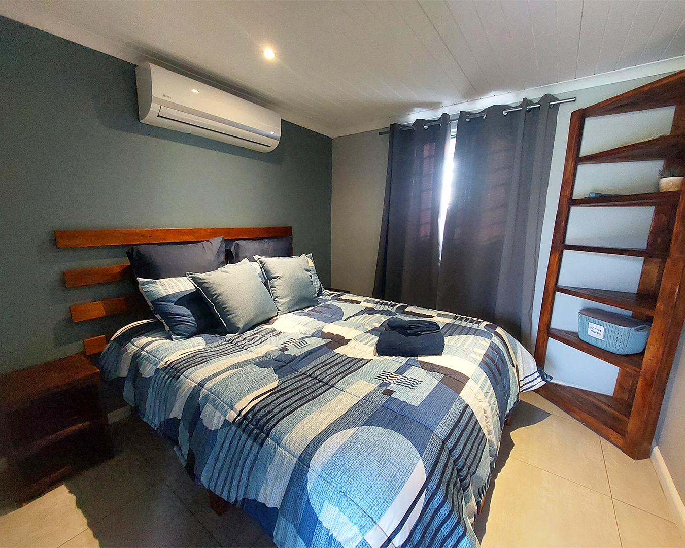 Farm cottage main bedroom with queen bed and air conditioning