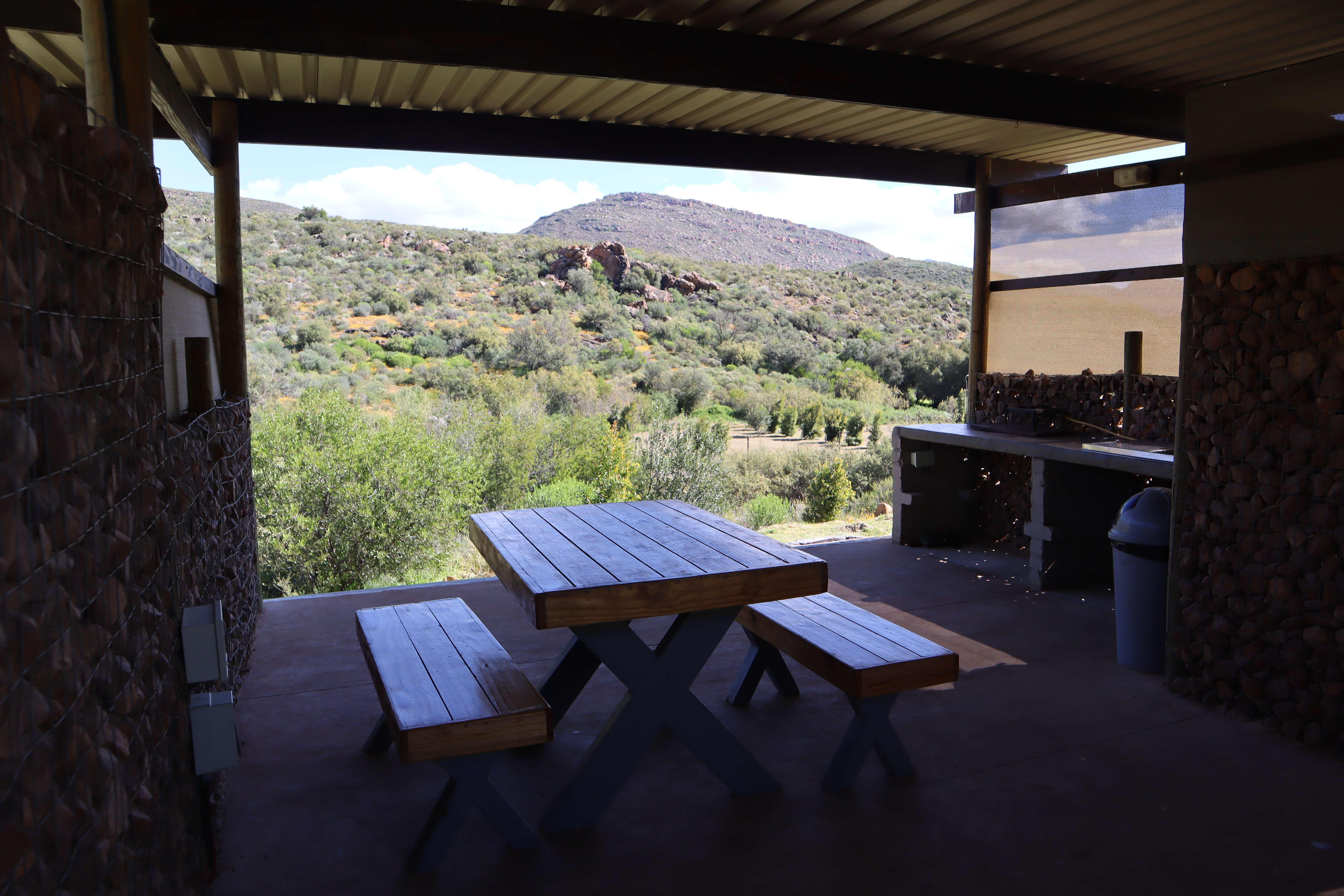 Taaibos campsite dining area with mountain views and wooden furniture